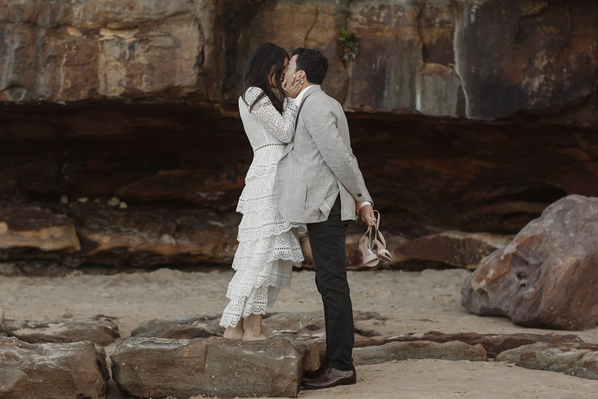 bride-kissing-groom-cliff